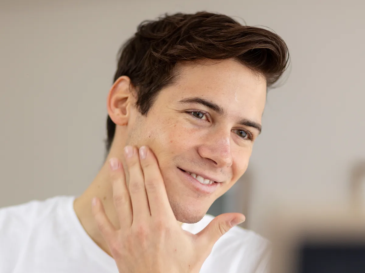 Man checking his face in the mirror