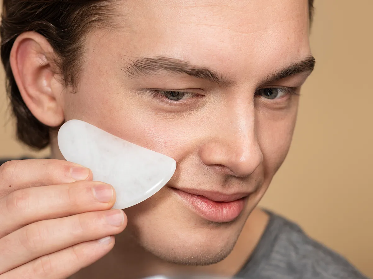 Man removing toner with cotton pad during Korean skincare for men routine