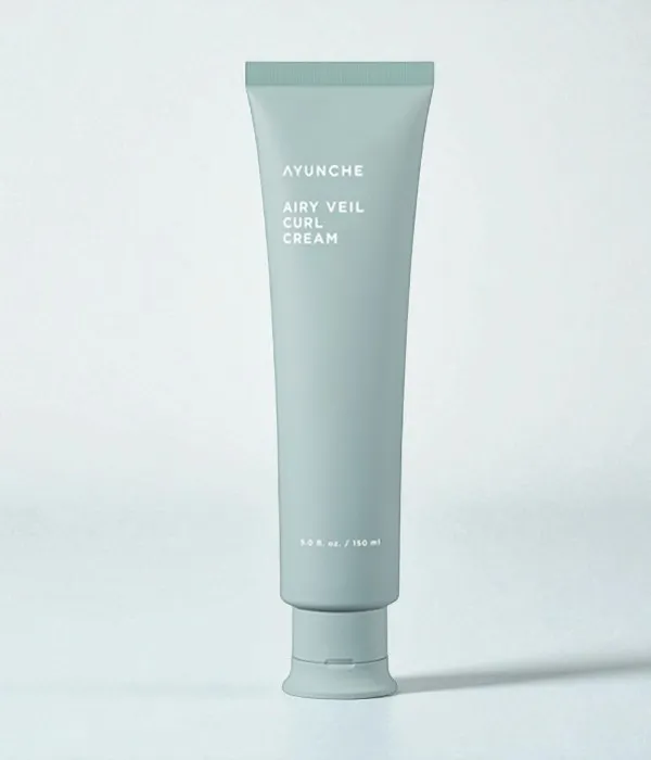 Light green Korean curl cream tube displayed against a mint green background