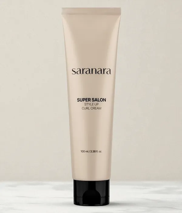 Beige Korean hair styling product for curls placed on a tabletop