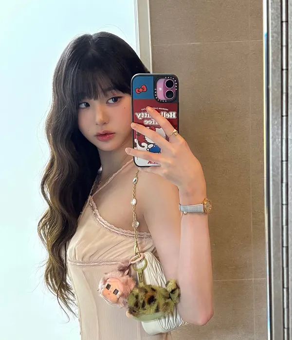 Jang Wonyoung with a Korean female hairstyle featuring long wavy hair, layered cloud perm, and soft bangs
