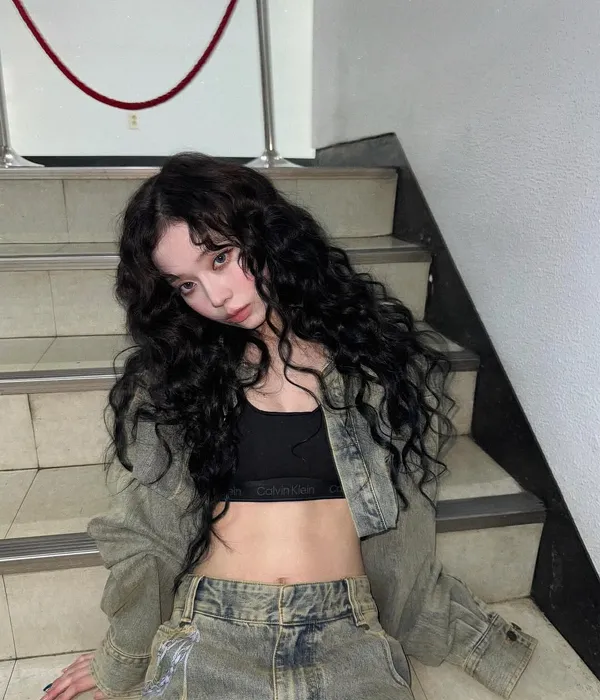 Winter with a thick hippie perm hairstyle, showing voluminous, textured waves