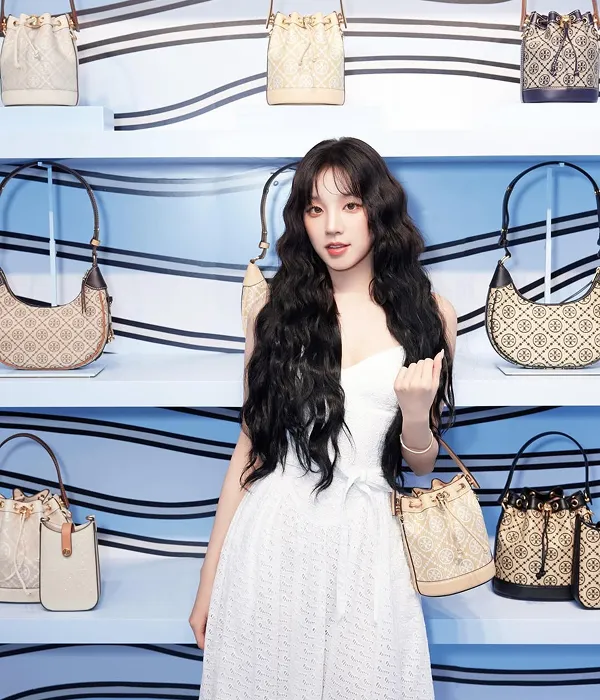 G-IDLE Yuqi wearing a long white dress with long, flowing beach waves