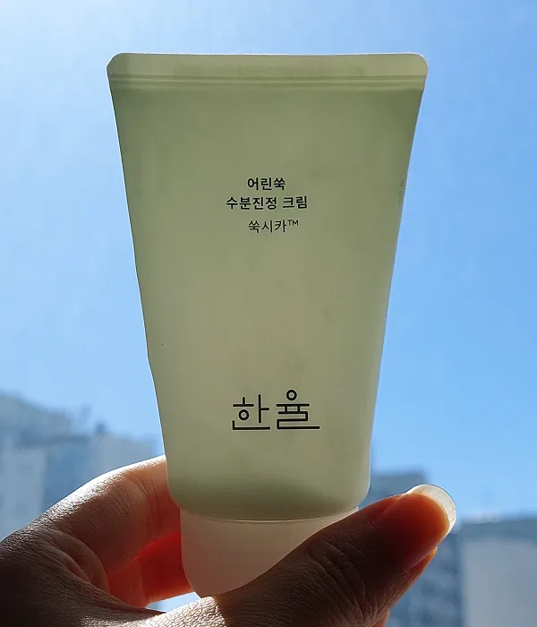 Backlit image of the Hanyul Pure Artemisia Cream, showing the remaining amount of product inside.