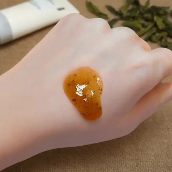 The thick, jam-like consistency of Isntree Green Tea Cleanser appears smooth and slightly translucent, with a rich, viscous texture that clings to the surface