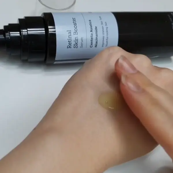 Applying the Meditherapy Retinal Skin Booster Serum on the back of the hand for testing